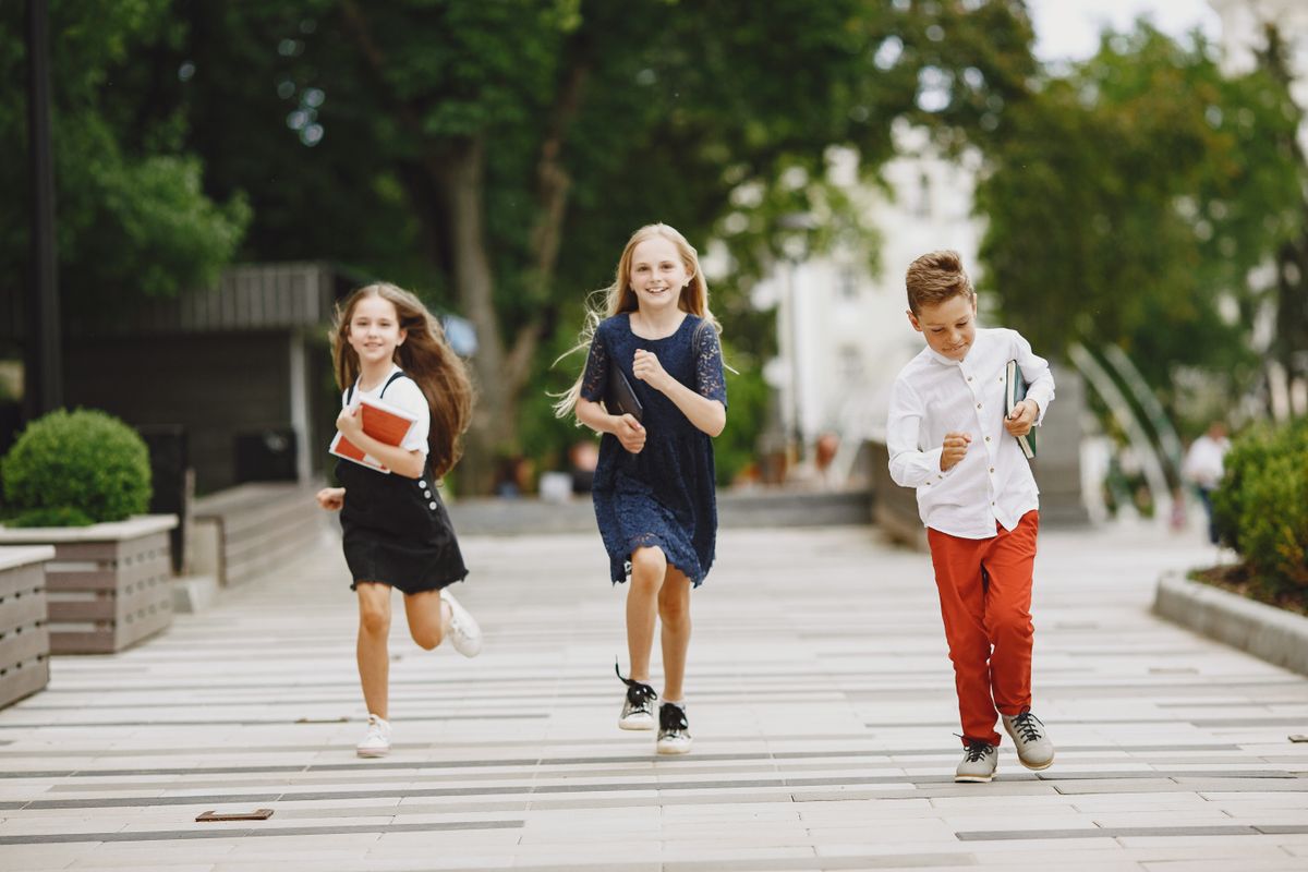 Happy children running and playing outdoors together